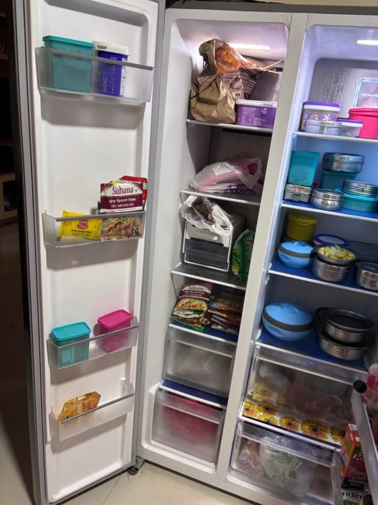 Voltas Beko 563 L side by side refrigerator side door storage showing multi-level door racks and bins for bottles, jars, and small containers.